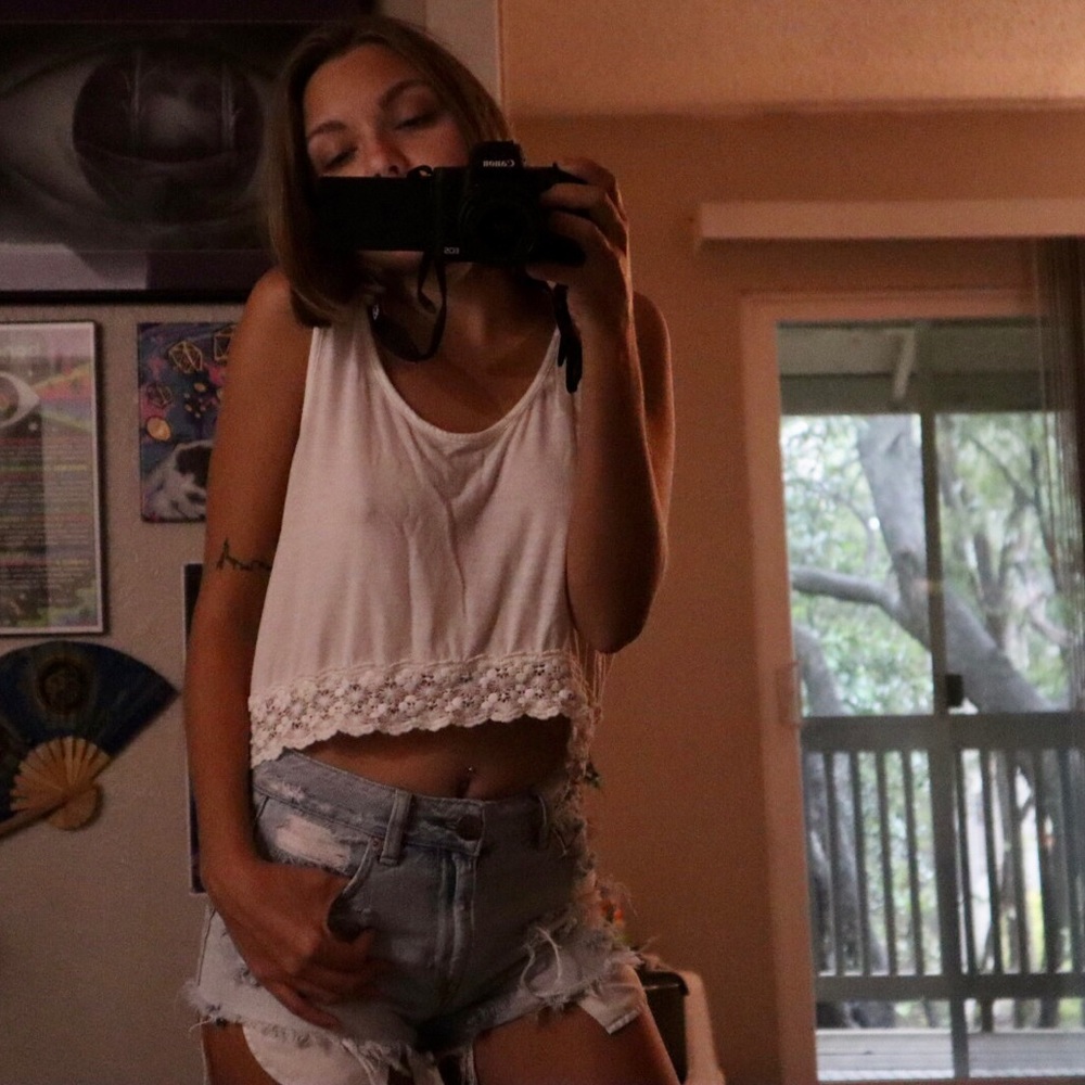 Simple white crop top with open back and flower details